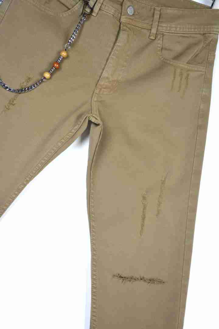 Jeans capri strappati sul ginocchio con catenella